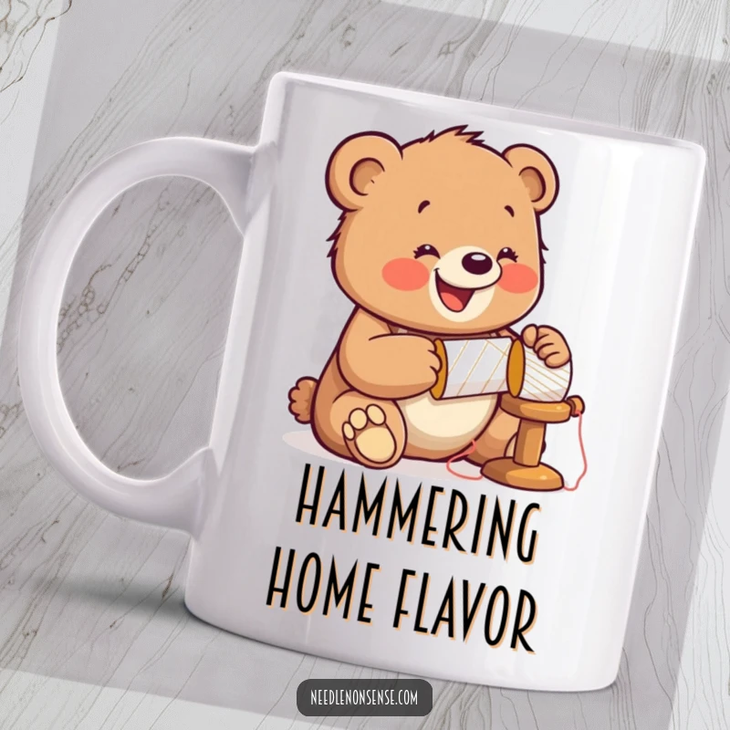 Funny Bear Sewing Mug, showing a jolly cub enthusiastically hammering a spool of thread while wearing a thimble.