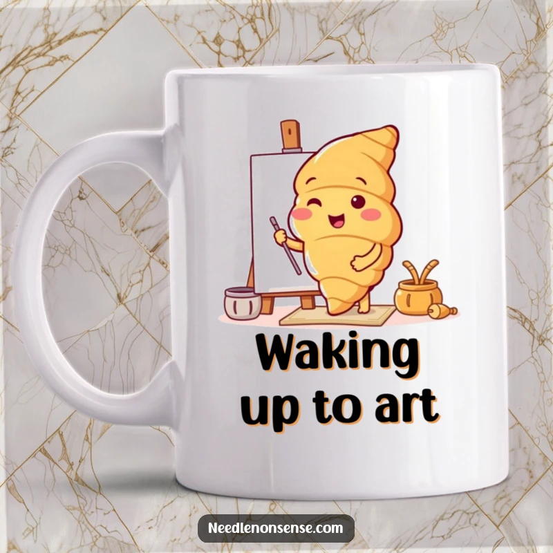 Funny mug depicting a cheerful croissant character enthusiastically preparing a blank canvas, ready to paint.