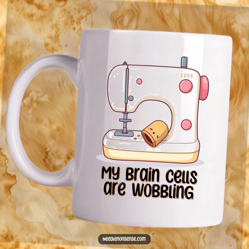 Funny mug showing a sewing thimble wobbling comically as it falls off a sewing machine, perfect for gift-givers.