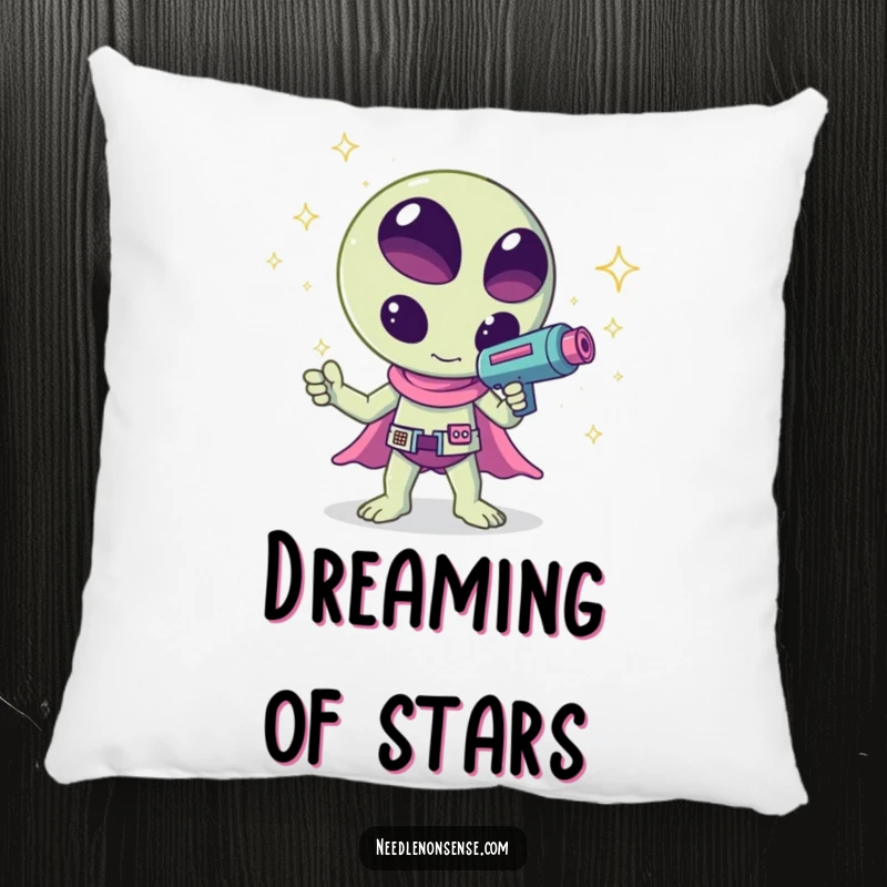 Funny kawaii alien waving a ray gun that shoots sparkles, a humorous and cuddly design on this pillow, great for comfort.