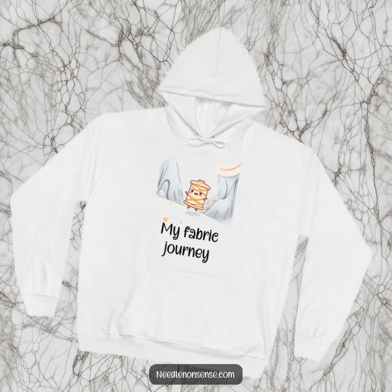 Funny hoodie showing a happy spool of thread character zipping energetically across a stitched fabric landscape, full of speed.