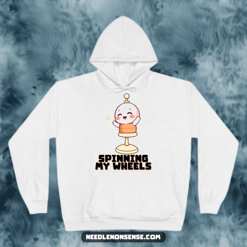 Funny hoodie depicting a giggling bobbin character spinning joyfully, offering warmth and humor for sewing aficionados.