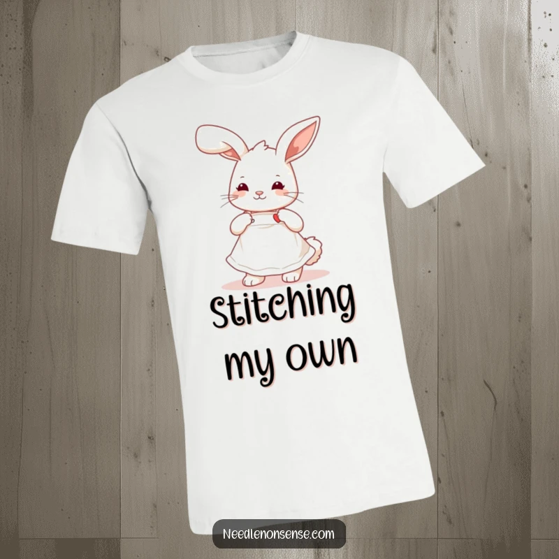 Funny playful bunny wearing a cute apron, stitching a tiny heart, a humorous and charming t-shirt design.