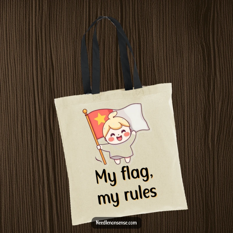 Funny tote bag showing a cheerful character sewing a smiling face onto a waving flag, perfect for carrying items with a happy message.